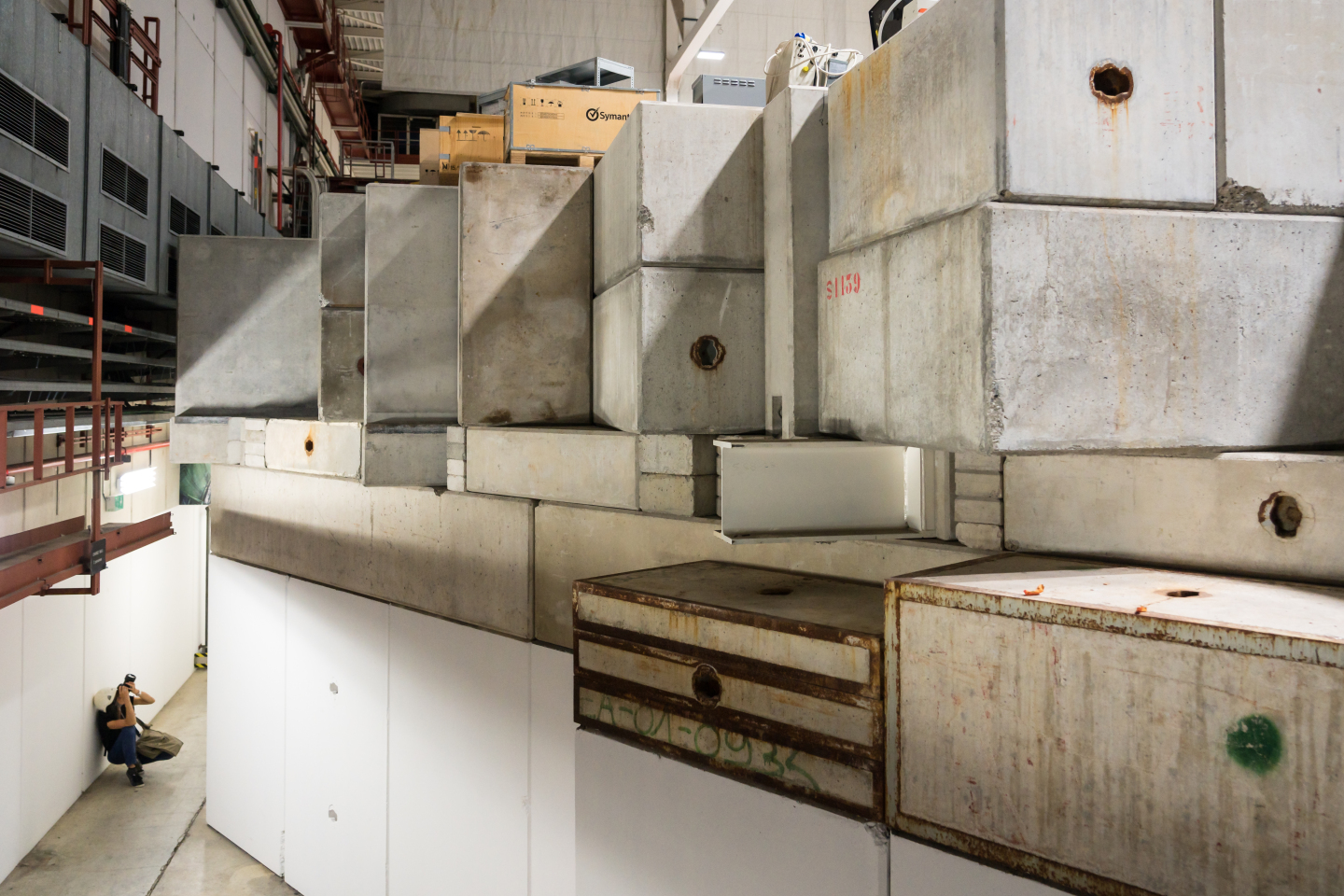 A photographer in front of concrete blocks in the antimatter hall, pictured by Cédric Favero. Photowalk 2018, 1st prize. (Image: Cédric Favero / CERN) 