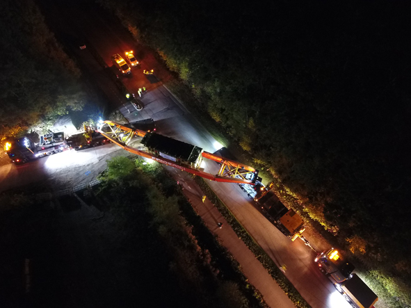 A convoy of trucks carrying a massive power transformer